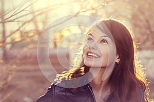 Happy young smile woman sunlight city portrait