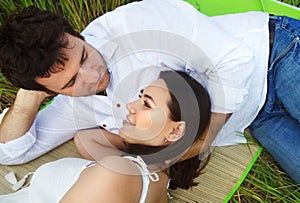 Happy young smiling couple on the summer meadow