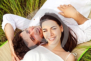 Happy young smiling couple on the summer meadow