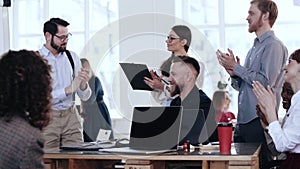 Happy young smiling diverse business people applause to speaker at office table after conference seminar training.