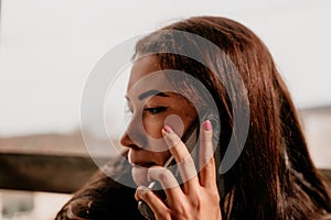 Happy young smiling woman with freckles outdoors portrait. Soft sunny colors. Outdoor close-up portrait of a young