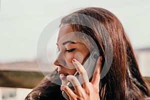 Happy young smiling woman with freckles outdoors portrait. Soft sunny colors. Outdoor close-up portrait of a young