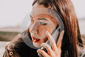 Happy young smiling woman with freckles outdoors portrait. Soft sunny colors. Outdoor close-up portrait of a young