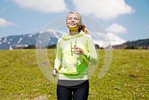 Happy young smiling woman jogging outdoors