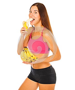 Happy young sports girl with bananas