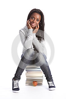 Happy young student girl with education books