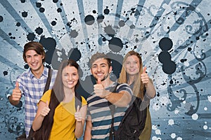 Happy young students against blue splattered background