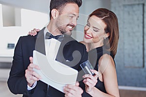 Happy young stylish couple online shopping by tablet and credit card