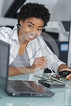 happy young technician fixing computer