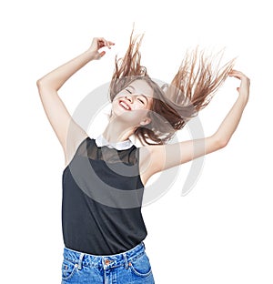 Happy young teenager girl with hands up and fluttering hair