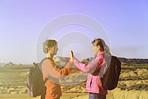 Happy young tourist couple hiking in mountains