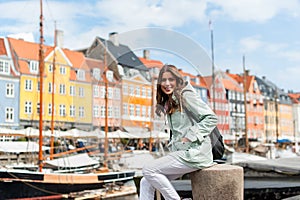 Happy young tourist woman with backpack at Copenhagen