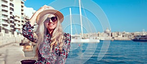 Happy young tourist woman in hat with mediterranean panorama