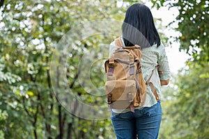 Happy young traveler woman backpacker travel in green natural forest ,greenery fresh air,Freedom wanderlust concept,Alone solo jo photo