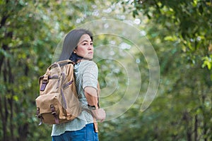Happy young traveler woman backpacker travel in green natural forest ,greenery fresh air,Freedom wanderlust concept,Alone solo jo