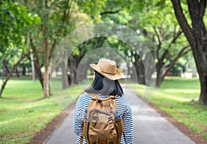 Happy young traveler woman backpacker travel in green natural forest ,greenery fresh air,Freedom wanderlust concept,Alone solo