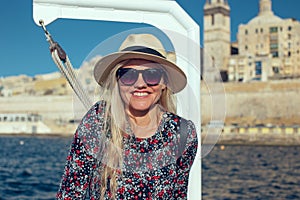 Happy young traveler woman traveling by ship on Mediterranean sea