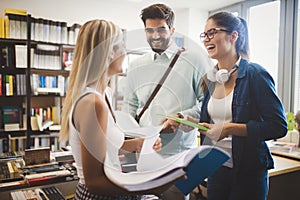 Happy young university students studying together. Group of multiracial friends in college