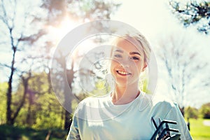 Happy young volunteer woman outdoors