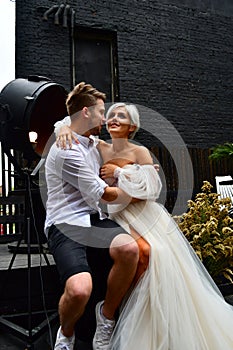 Happy young wedding couple kissing and hugging