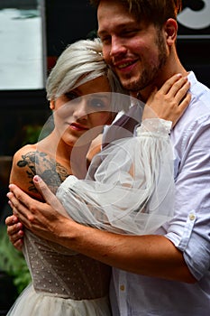 Happy young wedding couple kissing and hugging