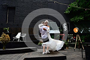 Happy young wedding couple kissing and hugging and waltz dancing