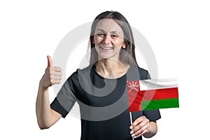 Happy young white woman holding flag of Oman and shows the class by hand isolated on a white background