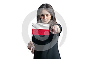 Happy young white woman holding flag of Poland and points forward in front of him isolated on a white background