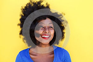 Happy young woman with afro hair smiling