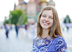 Happy young woman, against the background of the summer street