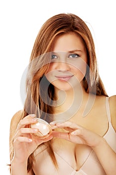 Happy young woman applying cream moisturizer