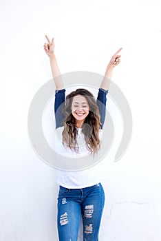 Happy young woman with arms raised up