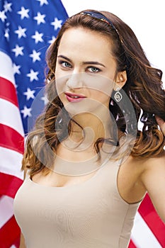 Happy young woman on a background of the American flag