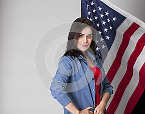 Happy young woman on a background of the American flag