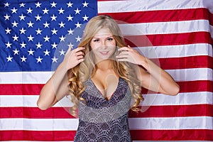 Happy young woman on a background of the American flag