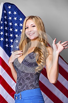 Happy young woman on a background of the American flag