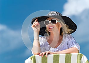 Happy young woman on the beach, beautiful female face outdoor portrait, pretty healthy girl relaxing outside, nature fun and joy,