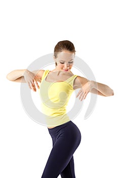 Happy young woman with beautiful slim body in yellow sport clothes - isolated