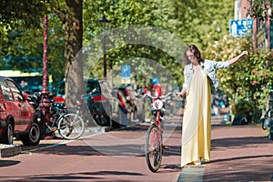 Happy young woman on bike in Amsterdam
