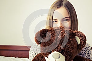 Teen girl with a teddy bear