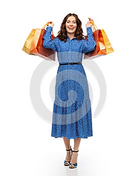 happy young woman in blue dress with shopping bags