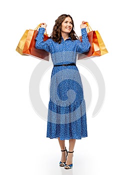 happy young woman in blue dress with shopping bags