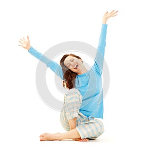 Happy young woman in blue pyjamas