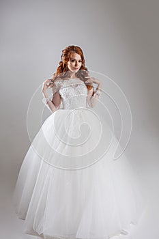 Happy young woman bride in a lavish wedding dress.