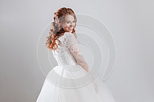 Happy young woman bride in a lavish wedding dress.