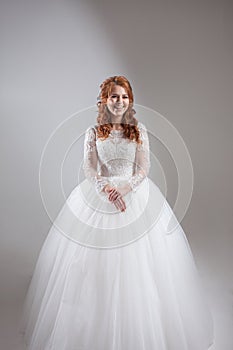 Happy young woman bride in a lavish wedding dress.