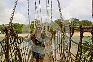 Happy young woman on the bridge in sentosa island, singapore