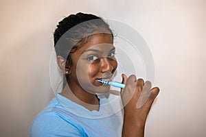 Happy young woman brushing teeth