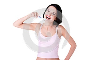 Happy young woman brushing teeth