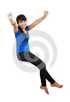 Happy young woman in casual wear sitting